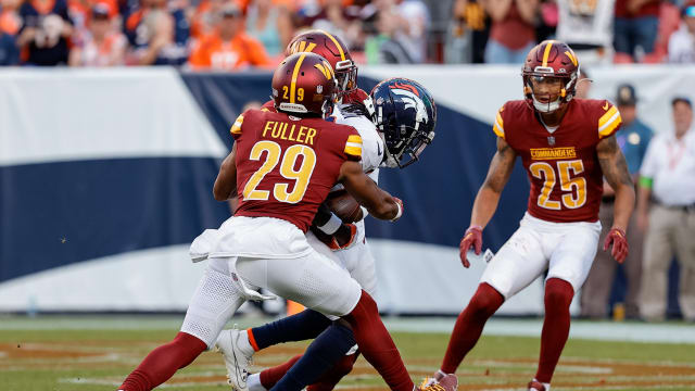 Denver Broncos wide receiver Brandon Johnson (89) scores a touchdown against Washington Commanders cornerback Kendall Fuller (29) and safety Percy Butler (35) as cornerback Benjamin St-Juste (25) looks on in the fourth quarter at Empower Field at Mile High. Mandatory Credit: Isaiah J. Downing-USA TODAY Sports
